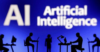 Figurines with computers and smartphones are seen in front of the words &quot;Artificial Intelligence AI&quot; in this illustration created on Feb. 19, 2024. (Reuters Photo)