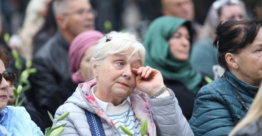 A woman wipes a tear as thousands of people bid farewell to Halid Beslic, the renowned Bosnian folk singer who passed away on Oct. 7, Sarajevo, Bosnia-Herzegovina, Oct. 13, 2025. (AA Photo)
