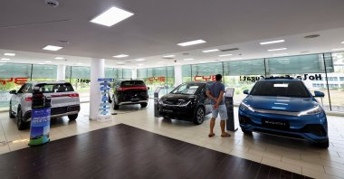A customer looks at a sign near cars at a BYD dealership in Sant Cugat del Valles, near Barcelona, Spain, Sept. 12, 2025. (Reuters Photo)