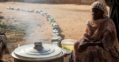 A Sudanese woman from a community kitchen prepares meals for people affected by conflict and extreme hunger, in Omdurman, Sudan, Sept. 19, 2024. (Reuters Photo)