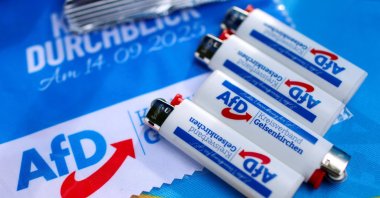 Promotional items lie on a table of an election campaign booth as Norbert Emmerich, candidate for Gelsenkirchen mayor from the Alternative for Germany party (AfD), campaigns on the streets ahead of the runoff of the North Rhine-Westphalian (NRW) local elections, in Gelsenkirchen, Germany, Sept. 24, 2025. (Reuters File Photo)