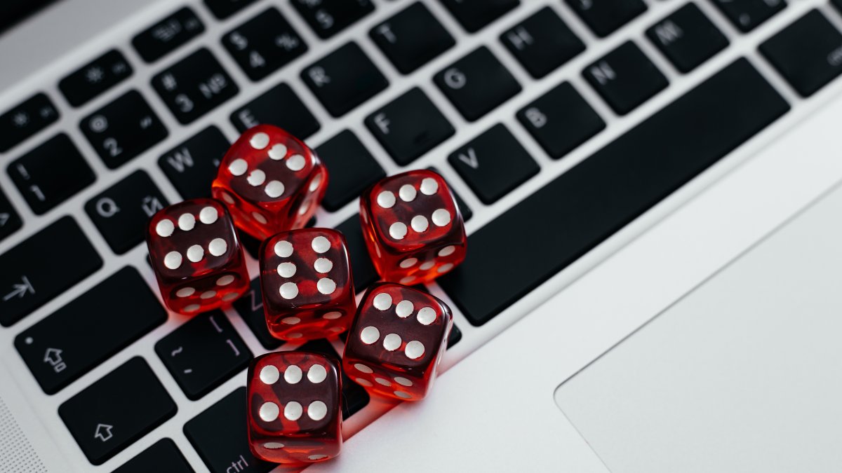 Dice on a computer keyboard symbolize the growth of online illegal gambling. (Shutterstock Photo)