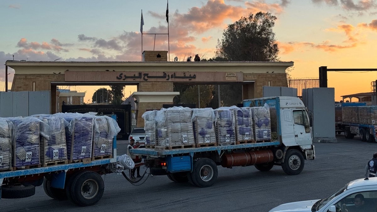 Trucks loaded with humanitarian aid on the Egyptian side of the Rafah crossing wait to cross into the Gaza Strip, Oct. 15, 2025. (AFP Photo)