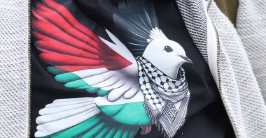 A dove, a symbol of peace, in the colors of the Palestinian flag, is seen on a shirt as protesters take part in a march and rally organized by Palestine Solidarity Campaign, Havant, U.K., Oct. 8, 2025. (Reuters Photo)