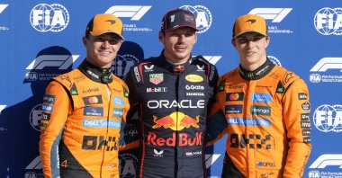 Red Bull driver Max Verstappen (C), celebrates his pole position with McLaren drivers Lando Norris (L) and Oscar Piastri after the qualifying session ahead of the Italian Grand Prix at the Monza racetrack, Monza, Italy, Sept. 6, 2025. (AP Photo)