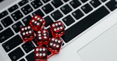 Dice on a computer keyboard symbolize the growth of online illegal gambling. (Shutterstock Photo)