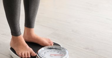 Measuring weight regularly is an important part of monitoring progress during obesity treatment. (Shutterstock Photo)