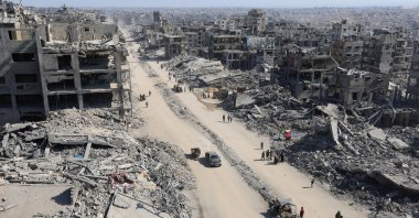 Palestinians walk past the rubble of destroyed buildings, amid a ceasefire between Israel and Hamas, in Gaza City, Oct. 16, 2025. (Reuters Photo)