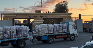 Trucks loaded with humanitarian aid on the Egyptian side of the Rafah crossing wait to cross into the Gaza Strip, Oct. 15, 2025. (AFP Photo)