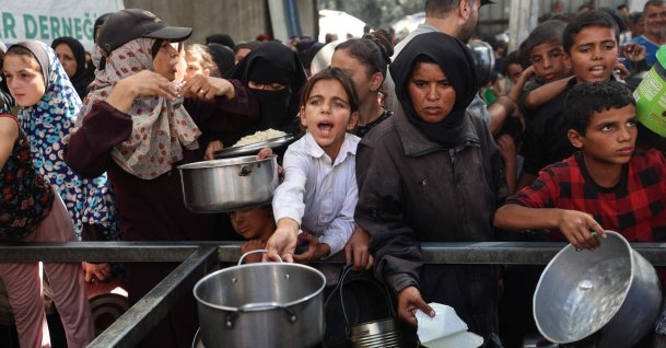 Palestinians gather to receive food portions from a charity kitchen in the Nuseirat refugee camp, located in the central Gaza Strip, Palestine, Oct. 15, 2025. (AFP Photo)