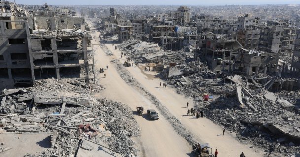 Palestinians walk past the rubble of destroyed buildings, amid a ceasefire between Israel and Hamas, in Gaza City, Oct. 16, 2025. (Reuters Photo)