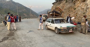 Volunteers stand on a road near the Pak-Afghan border in Kurram, Pakistan, Oct. 16, 2025. (EPA Photo)