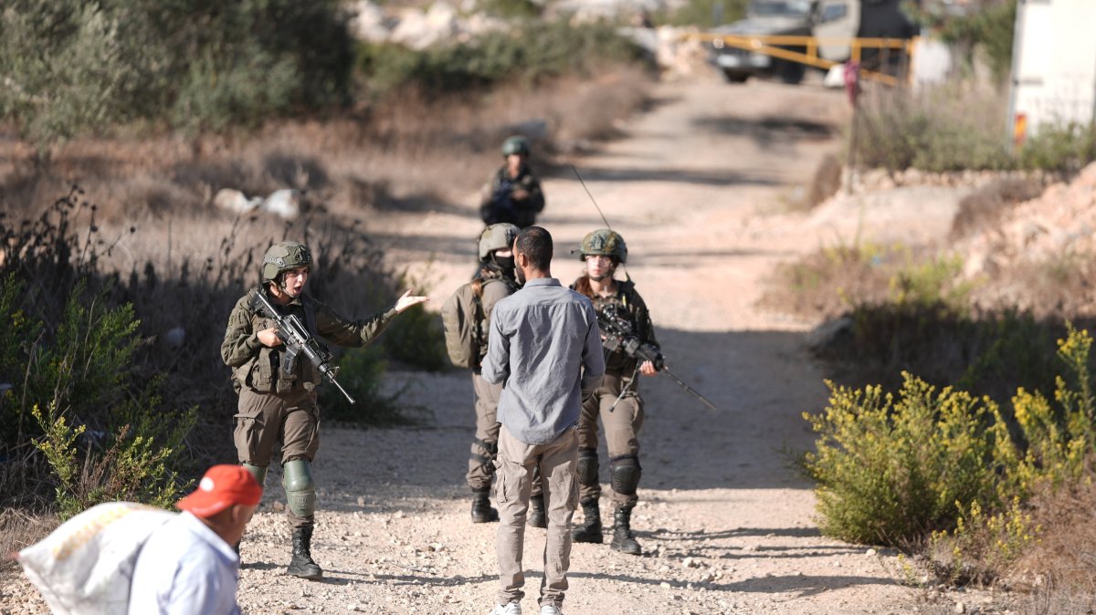 Israeli soldiers open fire on Palestinian farmers trying to reach their land for the olive harvest in the village of Kobar, near Ramallah in the occupied West Bank, Oct. 18, 2025. (AA Photo)