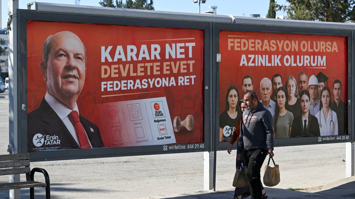 People walk by campaign billboards of incumbent president Ersin Tatar in the capital Lefkoşa (Nicosia), the Turkish Republic of Northern Cyprus (TRNC), Oct. 18, 2025. (AA Photo)