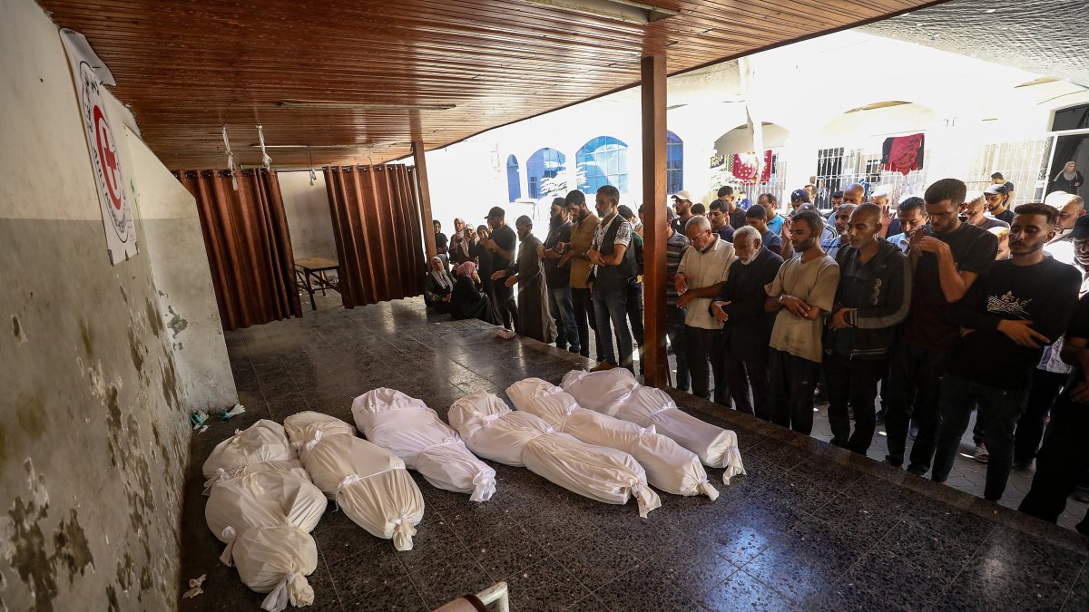 Palestinian relatives of the Abu Shaban family pray beside the bodies of their loved ones at Al Ahli Baptist Hospital in Gaza City, Palestine, Oct. 18, 2025. (EPA Photo)
