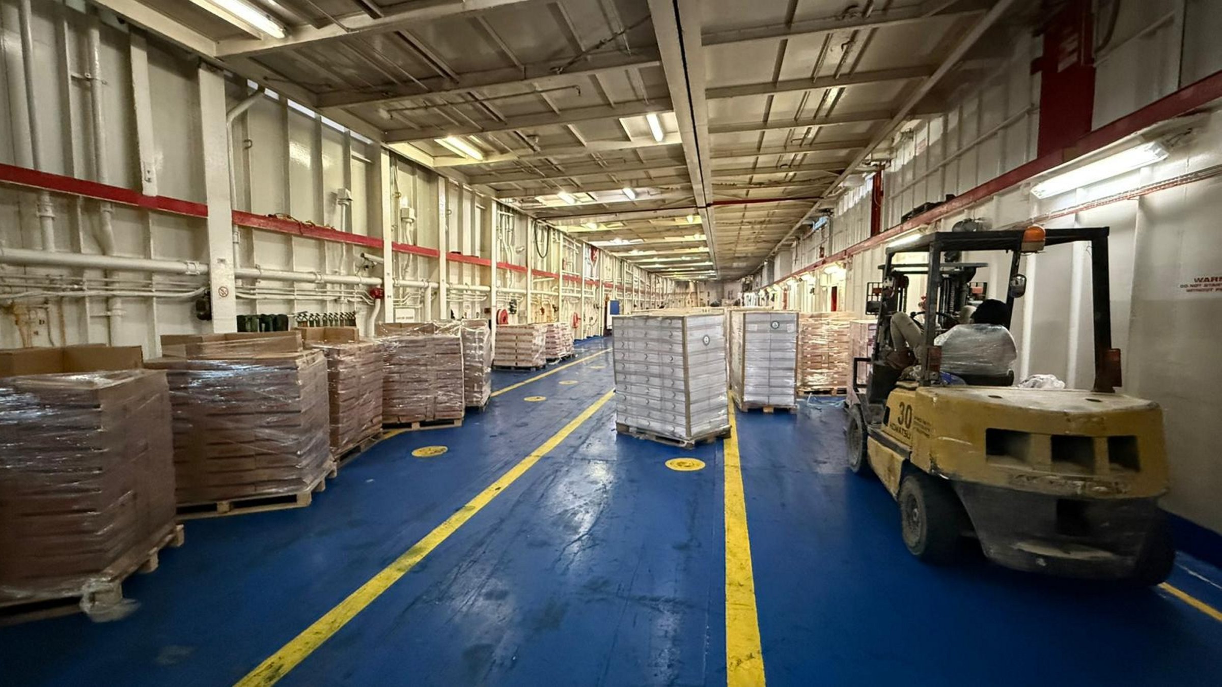 An interior view of the storage area where humanitarian aid from Türkiye’s 17th Ship of Goodness is organized before being sent to Gaza, at the Port of el-Arish Port, Egypt, Oct. 19, 2025. (AA Photo)