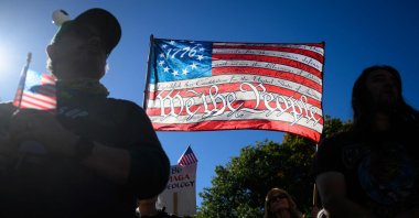 A demonstrator holds a sign during the &quot;No Kings&quot; protest to denounce the Trump administration, Portland, Oregon, U.S., Oct. 8, 2025. (AFP Photo)
