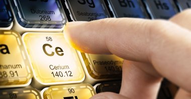 A finger pushes a square with the chemical element Cerium, one of the rare earth elements, on a periodic table. (Shutterstock Photo)