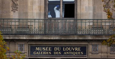 Members of a forensic team inspect a window believed to have been used in what the French Interior Ministry said was a robbery at the Louvre museum during which jewelry was stolen, in Paris, France, Oct. 19, 2025. (Reuters Photo)