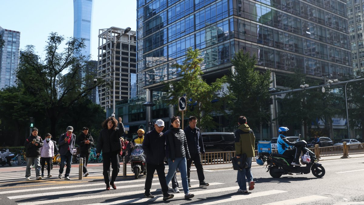 People walk in the Central Business District (CBD) area, Beijing, China, Oct. 20, 2025. (EPA Photo)