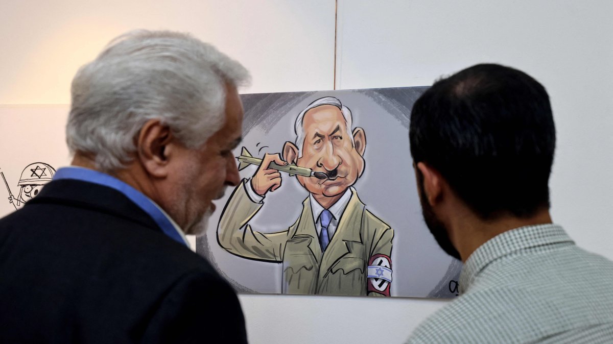 Iranians visit a cartoon exhibition called &quot;Symphony of Crime&quot;, marking the second anniversary of the Oct. 7, Tehran, Iran, Oct. 7, 2025. (AFP Photo)