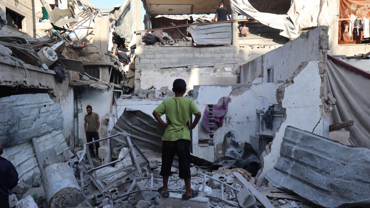 Palestinians inspect the damage around their homes after an Israeli strike targeted the previous day the Bureij refugee camp in the central Gaza Strip, Oct. 20, 2025. (AFP Photo)