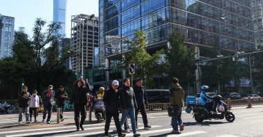 People walk in the Central Business District (CBD) area, Beijing, China, Oct. 20, 2025. (EPA Photo)