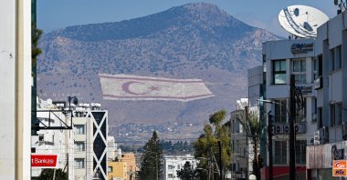 A flag of the Turkish Republic of Northern Cyprus (TRNC) is seen on the slopes of the Beşparmak Mountains overlooking Lefkoşa (Nicosia), TRNC, Oct. 18, 2025. (AA Photo)