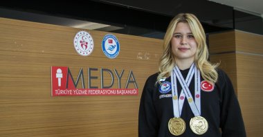 Turkish para swimmer Defne Kurt poses for a photo with her 2025 World Para Swimming Championships gold medals, Ankara, Türkiye, Oct. 10, 2025. (AA Photo) 