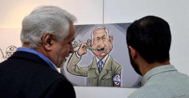 Iranians visit a cartoon exhibition called &quot;Symphony of Crime&quot;, marking the second anniversary of the Oct. 7, Tehran, Iran, Oct. 7, 2025. (AFP Photo)
