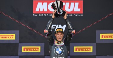 Turkish rider Toprak Razgatlıoğlu celebrates on the podium after winning the 2025 World Superbike Championship, lifting the trophy high as he secures his third world title, at Jerez Circuit, Jerez, Spain, Oct. 19, 2025. (AA Photo)