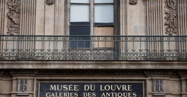 A view of a broken window protected by a wooden panel at the Louvre Museum as the museum remains closed the day after a spectacular jewel heist by thieves who broke into the landmark by using a crane and smashing an upstairs window, stealing priceless jewelry from an area that houses the French crown jewels before escaping on motorbikes, Paris, France, Oct. 20, 2025. (Reuters Photo)