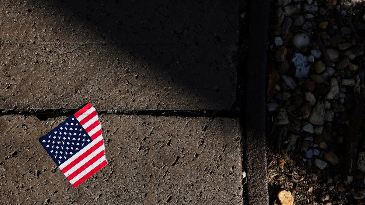 A torn American flag sticker lies on the ground, Washington, D.C., U.S., Oct. 20, 2025. (Reuters Photo)