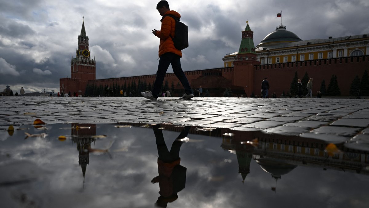 A person walks along Red Square past the Kremlin compound on an autumn day in central Moscow, Russia, Oct. 14, 2025. (AFP Photo)