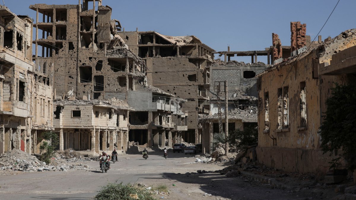 People ride motorcycles through a devastated street in Deir ez-Zor province, Syria, Sept. 30, 2025. (Reuters Photo)