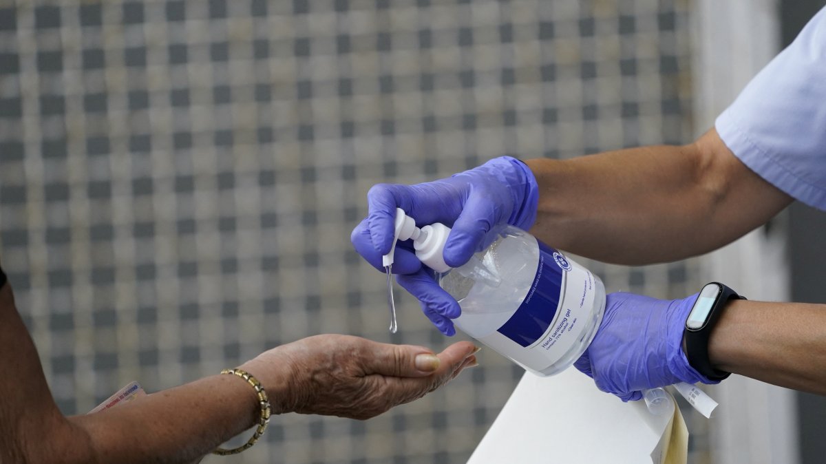 A medical team administers hand sanitizer to a resident of the Basque town of Azpeitia, Spain, Aug. 17, 2020. (Reuters File Photo)