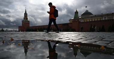 A person walks along Red Square past the Kremlin compound on an autumn day in central Moscow, Russia, Oct. 14, 2025. (AFP Photo)