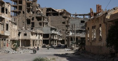 People ride motorcycles through a devastated street in Deir ez-Zor province, Syria, Sept. 30, 2025. (Reuters Photo)