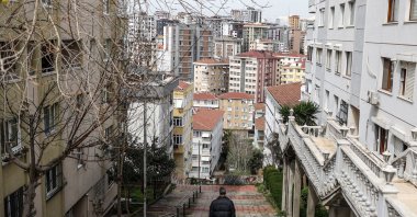 A man walks amid apartment buildings in the Maltepe district, Istanbul, Türkiye, April 3, 2023. (EPA Photo)