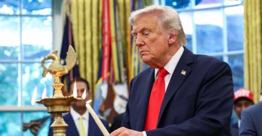 U.S. President Donald Trump lights a candle as he participates in a Diwali celebration in the Oval Office of the White House in Washington,D.C., U.S., Oct. 21, 2025. (Reuters Photo)