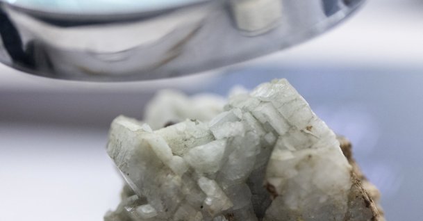 A sample of monazite, a mineral used in the rare earth industry to extract elements such as cerium, lanthanum, and neodymium, is displayed next to a magnification glass at the Geological Museum of China in Beijing, China, Oct. 14, 2025. (Reuters Photo)