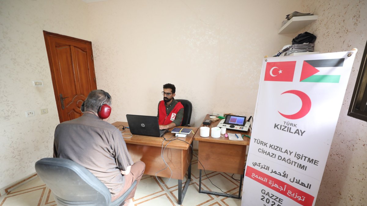 A Turkish Red Crescent (Kızılay) team member assists a patient with a hearing aid, Gaza, Palestine, Oct. 22, 2025. (AA Photo)