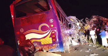 People gather at the scene of a multiple vehicles collision that left several people dead near Gulu, Uganda, Oct. 22, 2025. (AP Photo)