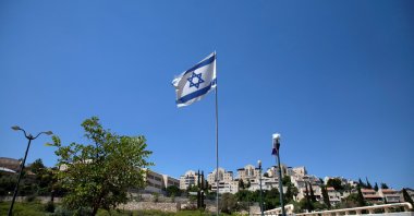 The Israeli national flag flutters as apartments are seen in the background in the Israeli settlement of Maale Adumim in the Israeli-occupied West Bank, Aug. 16, 2020. (Reuters Photo)