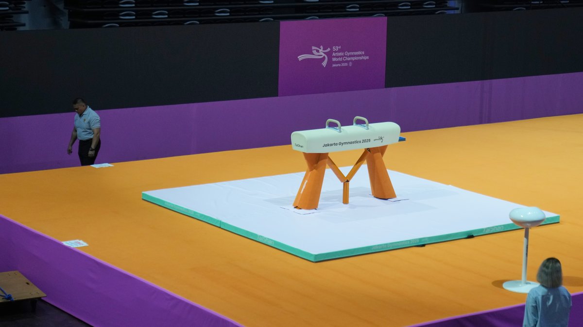 A security guard walks past a pommel horse at the venue prepared for the Artistic Gymnastics World Championships at Indonesia Arena, Jakarta, Indonesia, Oct. 10, 2025. (AP Photo)