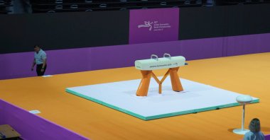 A security guard walks past a pommel horse at the venue prepared for the Artistic Gymnastics World Championships at Indonesia Arena, Jakarta, Indonesia, Oct. 10, 2025. (AP Photo)