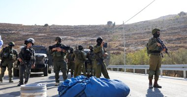 Members of the Israeli forces stand guard as they block the access of Palestinians and foreign activists to olive trees during the olive harvest, near Hebron, in the Israeli-occupied West Bank, Oct. 23, 2025. (Reuters Photo)
