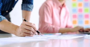 University graduates participate in a ceremony highlighting higher education achievements. (Shutterstock Photo) 