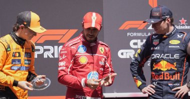 Ferrari driver Lewis Hamilton is flanked on the podium with McLaren driver Oscar Piastri (L) and Red Bull driver Max Verstappen after the sprint race ahead of the Chinese Formula One Grand Prix at the Shanghai International Circuit, Shanghai, China, March 22, 2025. (AP Photo)