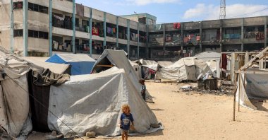 A girl stands outside one of the tents erected at a make-shift camp for people displaced by conflict in the yard of a school run by the United Nations Relief and Works Agency for Palestine Refugees (UNRWA), in Khan Younis in the southern Gaza Strip, Sept. 30, 2025. (AFP Photo)